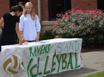 Shiva Boroojerdi, '15, talks to Jen Funsten, '15 at the Sand Volleyball Club table. Photo by Emi Myers.